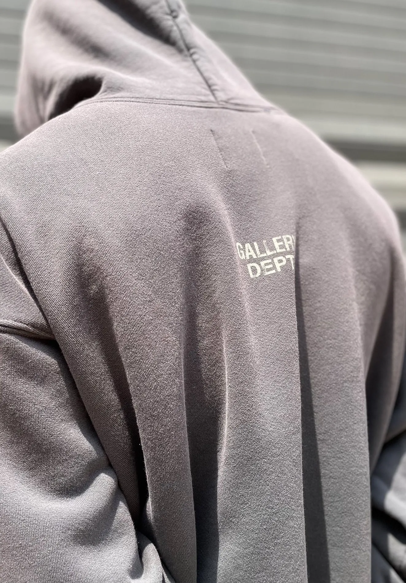 GALLERY DEPT. 90'S RECYCLE HOODIE WASHED BLACK 90'S washed hoodie with distressed eco-friendly slogans. Washed black S-XL. Ready-made garments are washed and dyed again. Multiple spots throughout the body are spray-faded. The ribs are cut and worn.